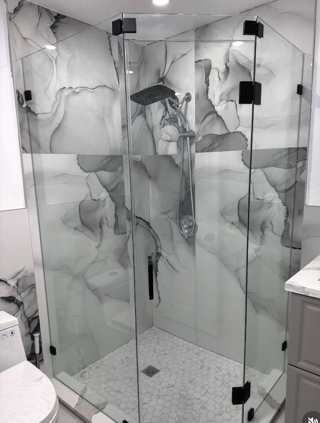 Corner glass shower enclosure with matte black hinges and handle