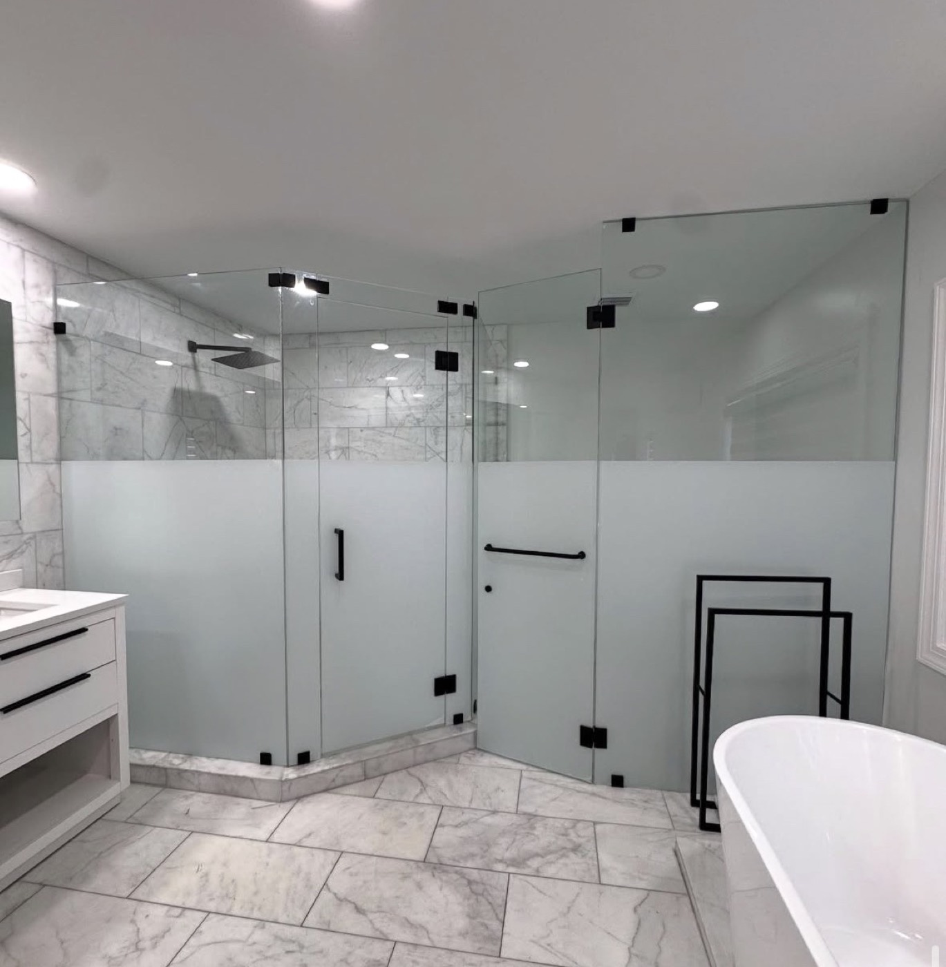 Corner shower enclosure with frosted privacy band and matte black hardware
