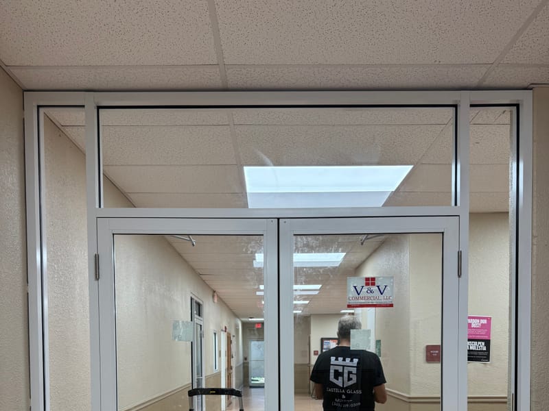 Castilla Glass installer hanging an impact double door on site
