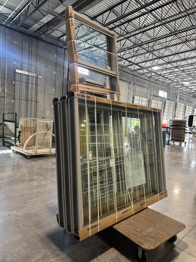 Finished bronze commercial picture windows (full view), wrapped on a cart