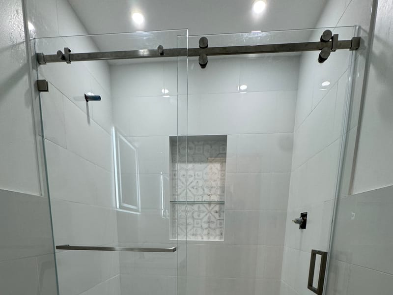 Frameless bypass shower door with a brushed-nickel bar