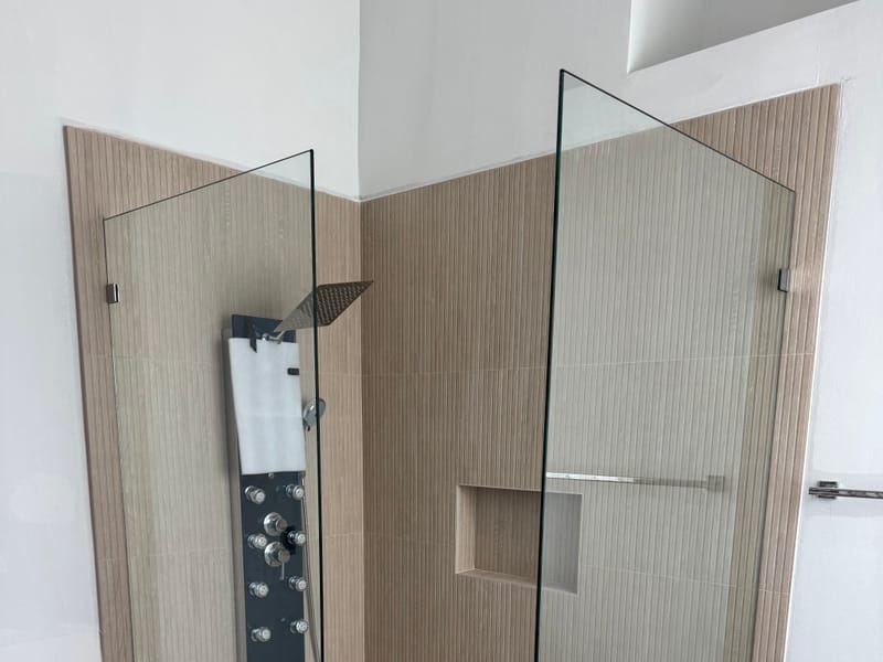 Fixed-panel walk-in shower with a pebble floor