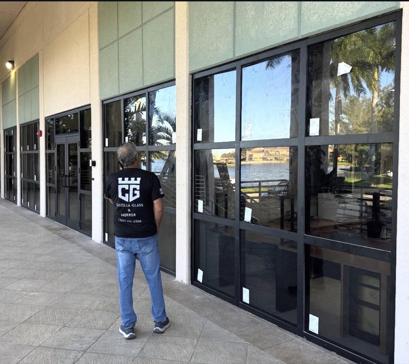 Castilla Glass installer checking new commercial glazing