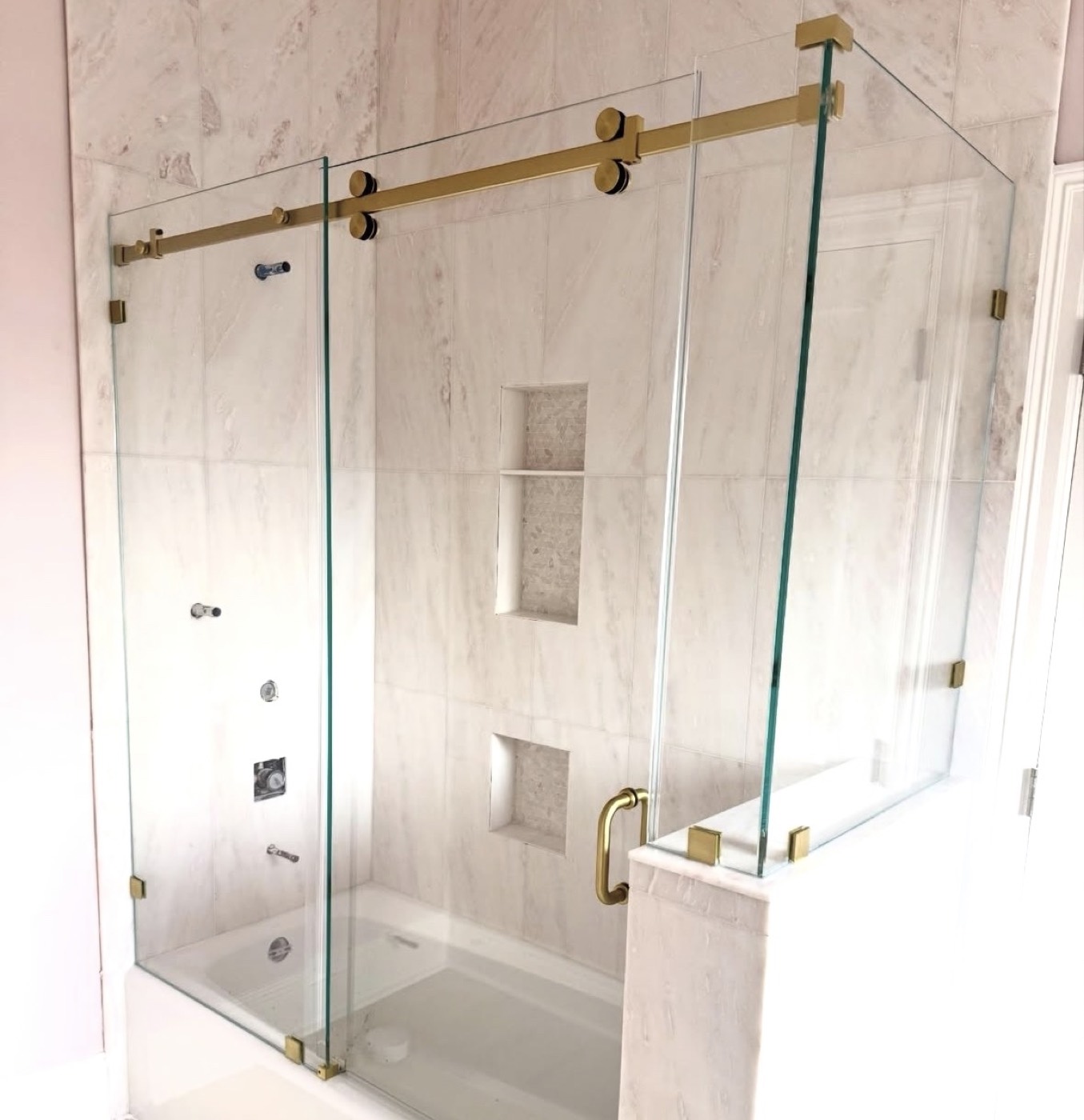 Custom frameless shower glass with gold hardware